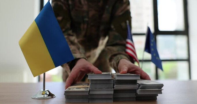 Military man passes lot of money dollars at negotiating table of ukraine with euro union and usa. Financial assistance to Ukraine in war against Russia