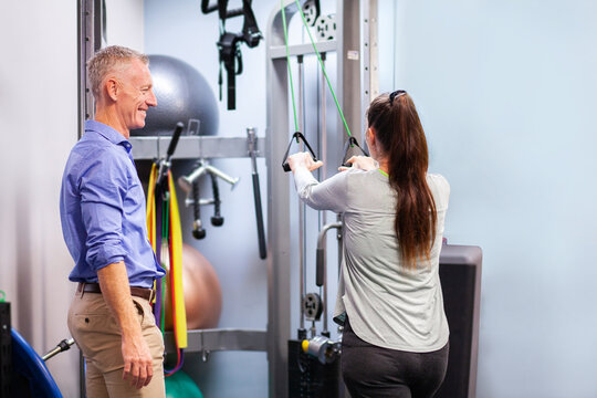 Physiotherapist working with client in clinic to recover from an injury