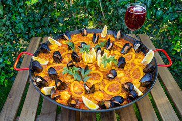Homemade Paella. Traditional Spanish food made with rice, 
seafood, shrimps, vegetables, mussels,...