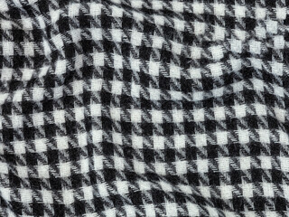 Black and white woolen houndstooth texture. Factory texture of woolen black and white scarf