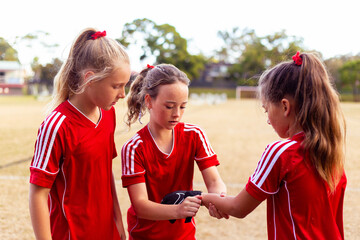 Soccer players help one another prepare for training