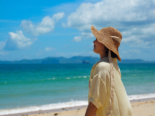 Asian female tourists wearing a hat by the sea vacation travel