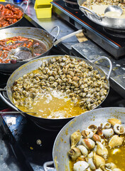 Vietnamese stewed seashells in sauce in the night market on food festival