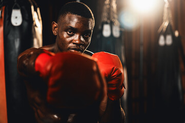 Boxing fighter shirtless posing, African American Black boxer punch his fist in aggressive stance...