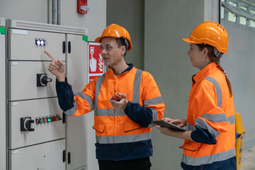 Two professional engineers checkmechanical check undercarriage of lifted electric train and...