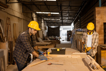 Carpenter worker in sawmill wood furniture factory joiner maker employee production team working with safety.