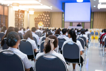 College students listening to seminar lectures in the hall