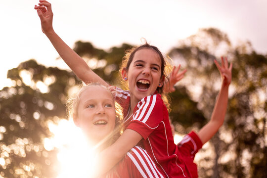 Happy Football Team Of Tween Girls Celebrating Together