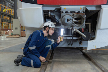 Engineer checks spare parts list and maintains mass transit locomotives in Asia