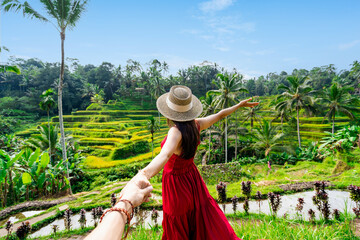 Young couple traveler looking at the beautiful tegalalang rice terrace in Bali, Indonesia