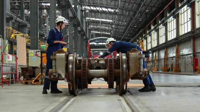 Engineer checks spare parts list and maintains mass transit locomotives in Asia