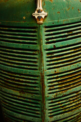 Texture of an industrial metal, vintage green color. Front of old industrial truck. Metal texture of a front of a truck or vintage car.