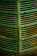 Texture of an industrial metal, vintage green color. Front of old industrial truck. Metal texture of a front of a truck or vintage car.