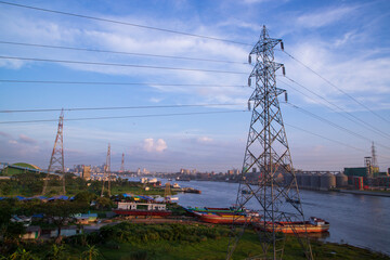 Aerial view of High voltage power line on the river and blue sky background, Bangladesh.