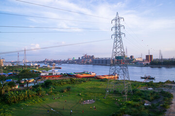Aerial view of High voltage power line on the river and blue sky background, Bangladesh.