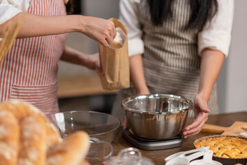 Asian female preparing homemade bakery ingredients.
