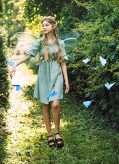 fairy girl with wings walks in the park