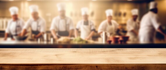 Wooden table on blur chefs cooking in the kitchen background in Restaurant