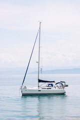 Recreational sailboat anchored off the coast during a cloudy day, adventure concept, travel,...