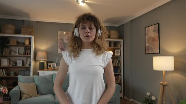 caucasian adult woman training at home hold kettlebell girya