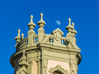 Image of the roofs of Gran Via street in Madrid with the crescent moon in the background