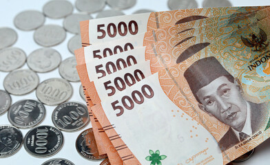 Coins and paper money with white background. Indonesian coin and paper currency