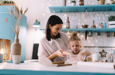 Mother and daughter cooking in kitchen