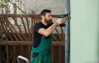 construction worker installing terrace roof on house