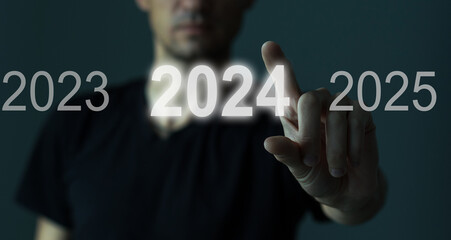 A man touching on virtual screen 2024. Business new year concept, welcome to year 2024 concept.
