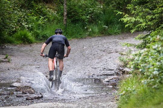 a mountain biker rides through the rivers.  A participant at The Raid of  The Hautes Fagnes in the region of Malmedy, Belgium