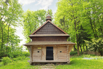 Fototapeta na wymiar Chapel (from the village of Yalynkuvate, Lviv region) in skansen Museum of Folk Architecture and Life 