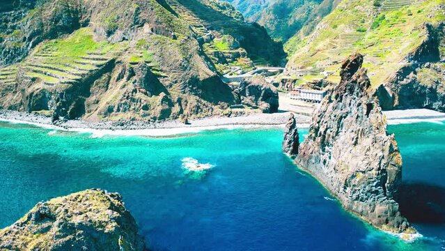 Aerial view of tall lava rocks in ocean, islet towers in Ribeira da Janela, Madeira, Portugal