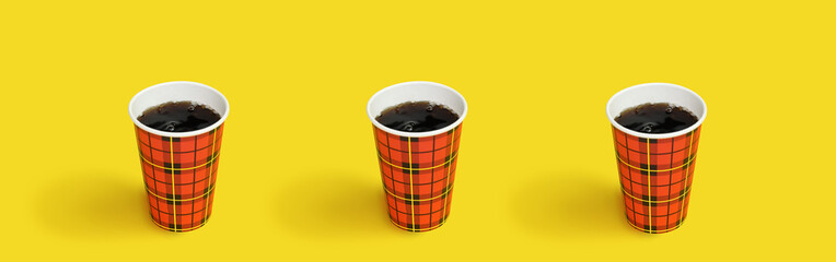 Cold bubble brown cola drink in red disposable paper cup, against yellow background. Disposable...
