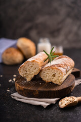 Obraz na płótnie Canvas Fresh homemade artisan loaf of baguette breads on rustic background with copy space. sourdough mini baguette breads.