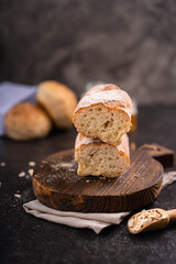 Fresh homemade artisan loaf of baguette breads on rustic background with copy space. sourdough mini baguette breads.