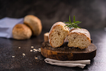 Fresh homemade artisan loaf of baguette breads on rustic background with copy space. sourdough mini baguette breads.