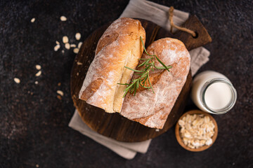 Fresh homemade artisan loaf of baguette breads on rustic background with copy space. sourdough mini baguette breads.