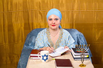 A Jewish woman in a kisui rosh headdress, a teacher of tradition, prepares for classes for women.