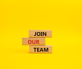 Join our team symbol. Wooden blocks with words Join our team. Beautiful yellow background. Business and Join our team concept. Copy space.
