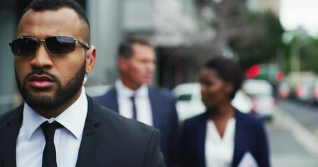 Serious African security guard and business people outdoor with protection for urban career. Bodyguard, walking and escort on street with sunglasses to protect professional in city with executives.