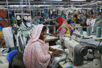 DHAKA, BANGLADESH - FEBRUARY 28, 2022: Women work at a ready-made garment factory in Dhaka,...
