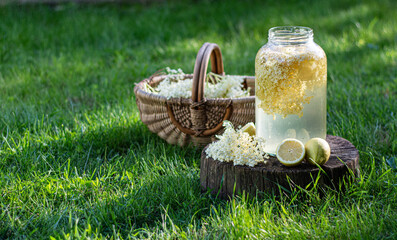homemade syrup of elderberry flowers in a glass jar