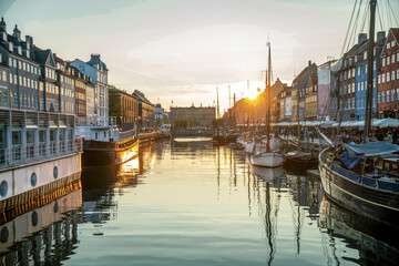 Saiboats in  harbor: landmark of Copenhagen Nyhavn, boats in sunset