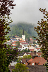 View at the parish church in Schoenberg, a small market town in lower bavaria during a misty morning in spring