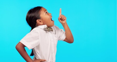 Hand pointing, wow and girl kid in studio surprised by news, deal or announcement on blue background. Finger, omg and female child portrait shocked by discount, sale or promo, coming soon or info