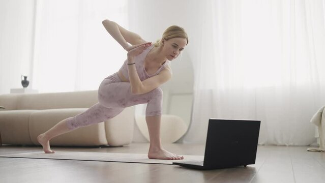 Meditation, fitness and yoga video laptop for home wellness practice with online coaching webinar. Young woman enjoying a mindfulness exercise training class with internet technology.