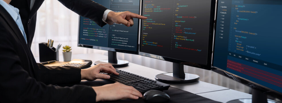 Software development team working together in office, coding script display on computer monitor. Programmer and software engineer working in tech developer company. Trailblazing