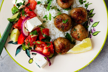 Greek style meatboll with rice and salad and tzatziki