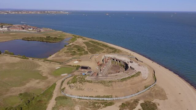 Fort Gilkicker a Palmerston Fort built between 1863 to 1871 on the Eastern end of Stokes by in Gosport to protect the entrance to Portsmouth harbour, aerial video.