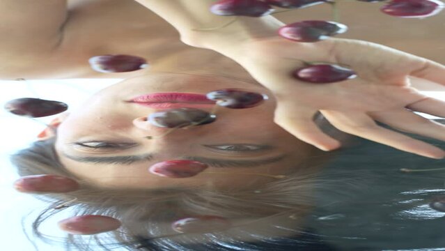 Woman eating cherries cherry woman glass mirror creative sensual skin beauty lips video vertical